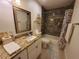 Bathroom featuring a granite vanity, tub with tile surround, floating shelves, and shower curtain at 1941 Spruce Creek Lndg, Port Orange, FL 32128