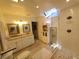Bathroom with dual vanity sinks, glass shower with skylight, and tiled floor at 1941 Spruce Creek Lndg, Port Orange, FL 32128