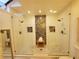 Modern bathroom featuring dual glass showers with mosaic tile walls and stone floors at 1941 Spruce Creek Lndg, Port Orange, FL 32128