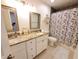 Bathroom featuring a double sink vanity with granite countertops and a shower/tub at 1941 Spruce Creek Lndg, Port Orange, FL 32128