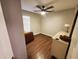 Bedroom featuring hardwood floors, neutral paint, a ceiling fan, and a window at 1941 Spruce Creek Lndg, Port Orange, FL 32128