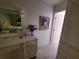 Bedroom featuring a dresser with mirror, white door, painting, and purple flowers in a vase at 1941 Spruce Creek Lndg, Port Orange, FL 32128