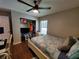 A comfortable bedroom featuring a ceiling fan, a closet, a window, and a dedicated workspace at 1941 Spruce Creek Lndg, Port Orange, FL 32128