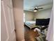 Cozy bedroom featuring a ceiling fan, a comfortable bed, and a dedicated workspace at 1941 Spruce Creek Lndg, Port Orange, FL 32128