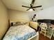 A comfortable bedroom featuring a fan, dresser and a dedicated workspace with multiple monitors at 1941 Spruce Creek Lndg, Port Orange, FL 32128