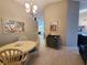 Bright dining area featuring an oval table, a chandelier, and decorative wall art at 1941 Spruce Creek Lndg, Port Orange, FL 32128