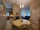 Bright dining area with round table, chandelier, and view of the kitchen and living room at 1941 Spruce Creek Lndg, Port Orange, FL 32128