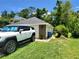 Exterior view of the home featuring an attached garage and well-maintained landscaping, adding to its curb appeal at 1941 Spruce Creek Lndg, Port Orange, FL 32128