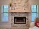 Close-up of a fireplace with a stone surround, wooden mantle, and decorative accents at 1941 Spruce Creek Lndg, Port Orange, FL 32128