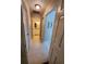 Hallway leads to a bathroom with double sinks and a shower/tub with a modern shower curtain at 1941 Spruce Creek Lndg, Port Orange, FL 32128