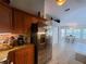 Bright kitchen features wood cabinets, granite countertops, and stainless steel refrigerator at 1941 Spruce Creek Lndg, Port Orange, FL 32128