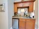 View of a kitchenette, complete with cabinets, stainless steel mini fridge and backsplash at 1941 Spruce Creek Lndg, Port Orange, FL 32128