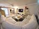 Spacious living room featuring a large sofa, entertainment setup, and modern design at 1941 Spruce Creek Lndg, Port Orange, FL 32128