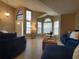 Open living room with vaulted ceilings, large windows, and modern furnishings at 1941 Spruce Creek Lndg, Port Orange, FL 32128