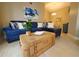 Bright living room features modern blue furnishings and wicker coffee table at 1941 Spruce Creek Lndg, Port Orange, FL 32128