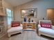 A comfortable living room features two armchairs, a fireplace, and a stylish mirror over a cabinet at 1941 Spruce Creek Lndg, Port Orange, FL 32128