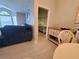 Cozy living room connects to bedroom with stylish furniture and plenty of natural light at 1941 Spruce Creek Lndg, Port Orange, FL 32128
