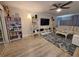 Relaxing living room featuring a white sofa, ladder shelves, and stylish decor at 1941 Spruce Creek Lndg, Port Orange, FL 32128