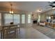 Sunlit living space featuring a stone fireplace, dining table, and large windows at 1941 Spruce Creek Lndg, Port Orange, FL 32128