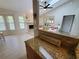Bright living space featuring a stone fireplace, ceiling fan, and an open floor plan at 1941 Spruce Creek Lndg, Port Orange, FL 32128