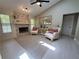Cozy living room featuring a fireplace with stone surround, mantle, and natural lighting at 1941 Spruce Creek Lndg, Port Orange, FL 32128