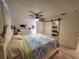 Cozy main bedroom with ceiling fan, barn door closet, and light hardwood floors at 1941 Spruce Creek Lndg, Port Orange, FL 32128