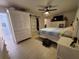 Bright main bedroom with light floors, a barn door closet, and ensuite bathroom at 1941 Spruce Creek Lndg, Port Orange, FL 32128