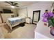 Spacious main bedroom with ceiling fan, dresser and mirror, and light hardwood floors at 1941 Spruce Creek Lndg, Port Orange, FL 32128