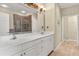 Bright bathroom featuring a double vanity, large mirror, and adjacent walk in shower at 1983 Turnbull Lakes Dr, New Smyrna Beach, FL 32168