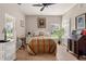Cozy bedroom with ample natural light, ceiling fan, a comfortable bed, and wood-look flooring at 1983 Turnbull Lakes Dr, New Smyrna Beach, FL 32168