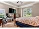 Bedroom with modern ceiling fan, large window, desk area, and spacious layout at 1983 Turnbull Lakes Dr, New Smyrna Beach, FL 32168