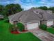 Charming townhome showcasing meticulous landscaping and a two-car garage at 1983 Turnbull Lakes Dr, New Smyrna Beach, FL 32168