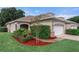 Charming single-Gathering home with manicured lawn, lovely landscaping, and an attached two-car garage at 1983 Turnbull Lakes Dr, New Smyrna Beach, FL 32168