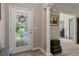 Bright foyer featuring tile flooring, a decorative column, and view of the front yard at 1983 Turnbull Lakes Dr, New Smyrna Beach, FL 32168