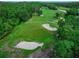 Picturesque golf course featuring lush greens, bunkers, and mature trees at 1983 Turnbull Lakes Dr, New Smyrna Beach, FL 32168