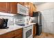 Well-equipped kitchen with stainless steel appliances, tiled backsplash, and ample cabinet space at 1983 Turnbull Lakes Dr, New Smyrna Beach, FL 32168