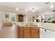 Open kitchen view with marble countertops, stainless steel sink, and stylish cabinetry, adjacent to a bedroom at 1983 Turnbull Lakes Dr, New Smyrna Beach, FL 32168