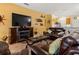 Spacious living room with fireplace, TV and stylish furniture, creating a cozy and inviting atmosphere at 1983 Turnbull Lakes Dr, New Smyrna Beach, FL 32168
