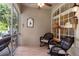Relaxing screened patio with wicker furniture, ceiling fan, and tiled floors, perfect for enjoying outdoor living at 1983 Turnbull Lakes Dr, New Smyrna Beach, FL 32168