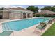 Community swimming pool with lounge chairs, perfect for relaxing and enjoying the Florida sunshine at 1983 Turnbull Lakes Dr, New Smyrna Beach, FL 32168