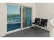 Balcony with chairs and sliding glass door, overlooking city and ocean view at 2 Oceans West Blvd # 702, Daytona Beach, FL 32118