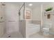 Bathroom featuring a soaking tub, walk-in shower with gray tiles and hand rails at 2 Oceans West Blvd # 702, Daytona Beach, FL 32118