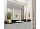 Well-lit bathroom vanity featuring black granite countertops and stylish decor for a refined look at 2 Oceans West Blvd # 702, Daytona Beach, FL 32118