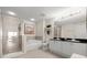Modern bathroom with double sinks, walk-in shower, soaking tub, and neutral color palette at 2 Oceans West Blvd # 702, Daytona Beach, FL 32118