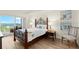 Bedroom with a view from the balcony with seating and paintings on the wall at 2 Oceans West Blvd # 702, Daytona Beach, FL 32118