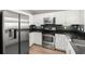 Bright kitchen with stainless steel appliances, dark granite countertops, and white cabinetry at 2 Oceans West Blvd # 702, Daytona Beach, FL 32118