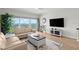 Cozy living room with comfortable seating, wood floors, and large windows with water views at 2 Oceans West Blvd # 702, Daytona Beach, FL 32118