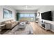 Bright living room featuring wood floors, large windows with water views, and comfortable seating at 2 Oceans West Blvd # 702, Daytona Beach, FL 32118