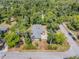 Aerial view of the property showcasing the home and surrounding mature trees at 200 W Washington Ave, Deland, FL 32720