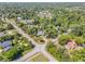 An aerial view shows the home nestled among mature trees near an intersection at 200 W Washington Ave, Deland, FL 32720